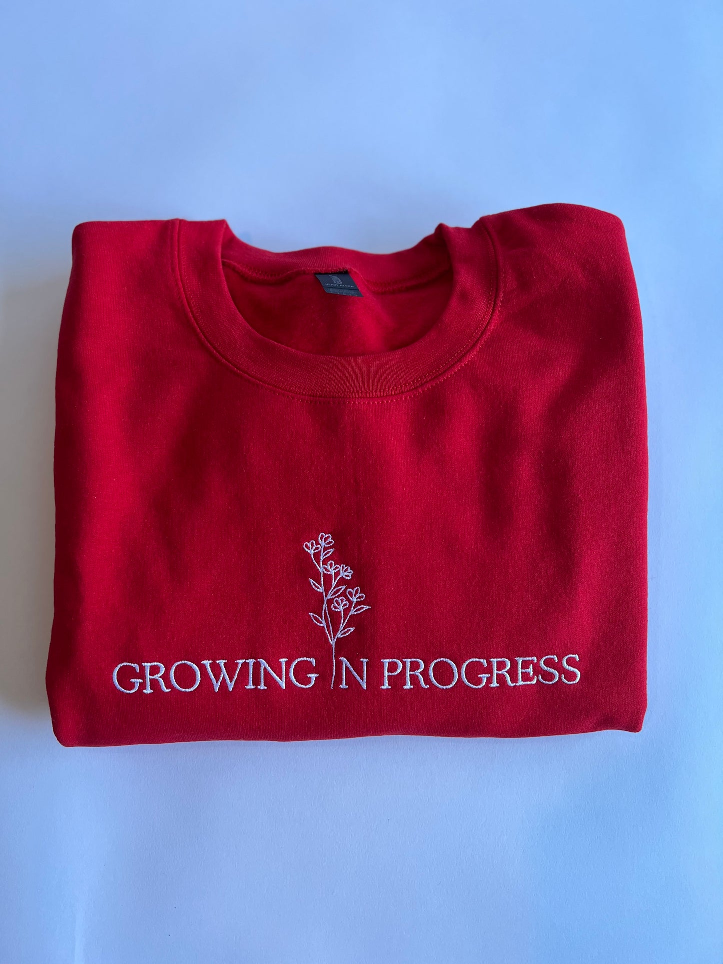 Growing in Progress Embroidered Red Crewneck