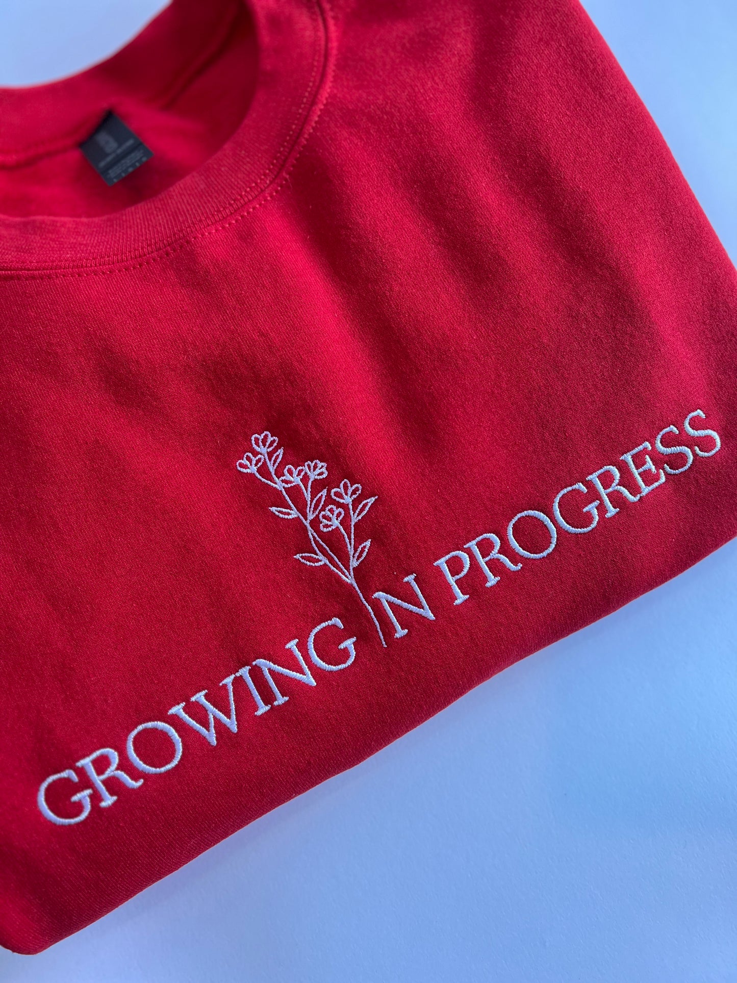 Growing in Progress Embroidered Red Crewneck